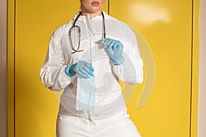 Doctor in nitrile gloves and stethoscope with a mask