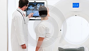 Doctor and nurse analyzing data of CT scan