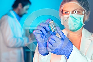 Doctor and nurse analyzing unknown MMR vaccine photo