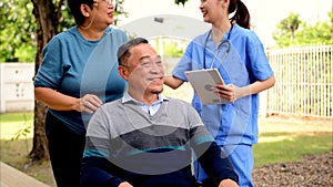 Doctor or nurse caregiver with senior patient at home or nursing home, Female doctor holding tablet visiting patient in