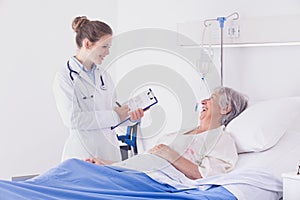 Doctor or nurse chatting to a senior woman patient