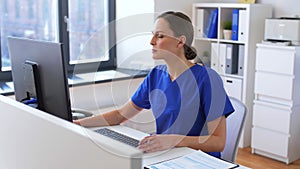Doctor or nurse with computer working at hospital