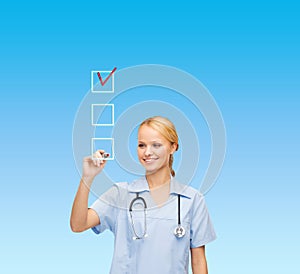 Doctor or nurse drawing checkmark into checkbox