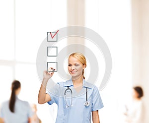 Doctor or nurse drawing checkmark into checkbox