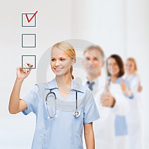 Doctor or nurse drawing checkmark into checkbox