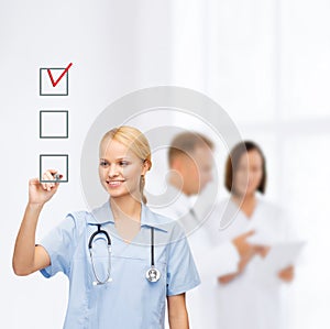 Doctor or nurse drawing checkmark into checkbox