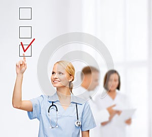 Doctor or nurse drawning checkmark into checkbox