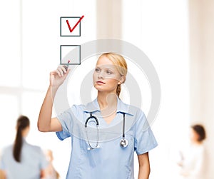 Doctor or nurse drawning checkmark into checkbox