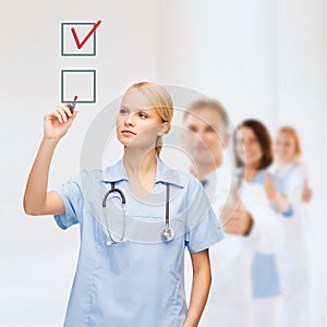 Doctor or nurse drawning checkmark into checkbox