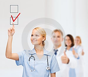 Doctor or nurse drawning checkmark into checkbox