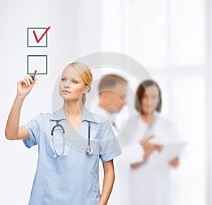 Doctor or nurse drawning checkmark into checkbox