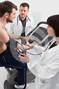 Doctor and nurse examination of cardiac stress test