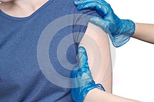 Doctor or nurse examine tuberculosis vaccine BCG marks on the shoulder of an adult woman made in childhood