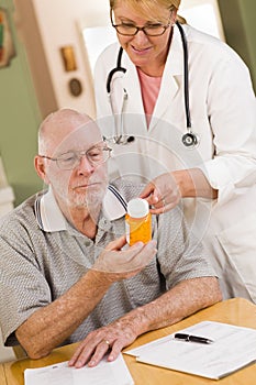 Doctor or Nurse Explaining Prescription Medicine to Senior Man