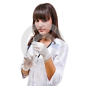 Doctor or nurse in face mask and lab coat holding syringe. Isolated over white.