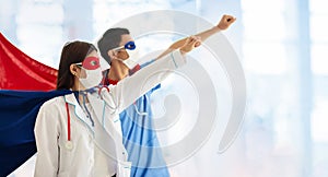 Doctor or nurse in face mask and superhero cape