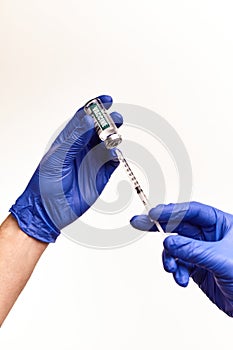 Doctor, nurse hand in blue gloves holding coronavirus covid-19 vaccine