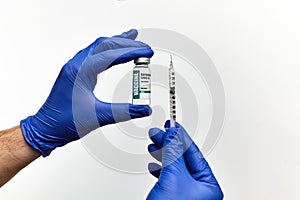Doctor, nurse hand in blue gloves holding coronavirus covid-19 vaccine