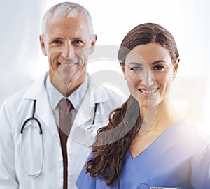 Doctor, nurse and happy together in portrait with smile, medical support and wellness in hospital. Medic, mature man and