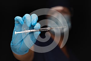 Doctor or Nurse Holding Medical Syringe with Needle