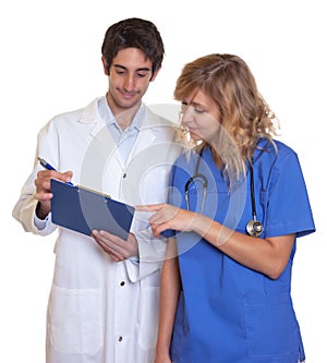 Doctor and nurse looking at clipboard