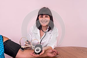 Doctor or nurse measure blood pressure on patient`s hand