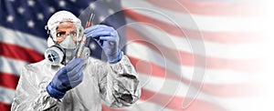 Doctor or Nurse In Medical Personal Protective Equipment PPE Against The American Flag Banner