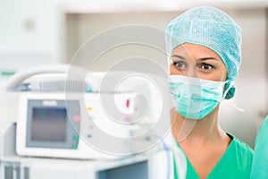 Doctor or nurse in operating room on heart monitor