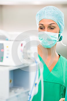 Doctor or nurse in operating room on heart monitor