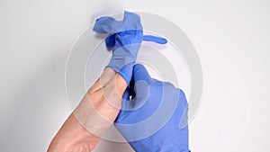 Doctor or nurse putting on blue nitrile surgical gloves, professional medical safety and hygiene for surgery and medical