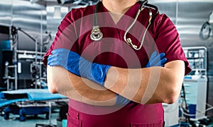 doctor or nurse in red uniform with stethoscope staning at emergency room