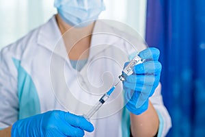 Doctor, nurse, scientist hand in blue gloves holding flu, measles, coronavirus, covid-19 vaccine disease preparing for child, baby