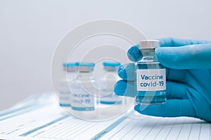 Doctor, nurse, scientist hand in blue gloves holding flu, measles, coronavirus, covid-19 vaccine disease preparing vaccination