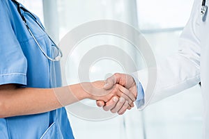 Doctor and nurse shaking hands