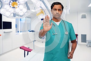 doctor or nurse showing stop gesture at clinic