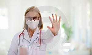 Doctor or nurse with stethoscope and face mask