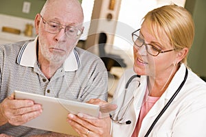 Doctor or Nurse Talking to Senior Man with Touch Pad