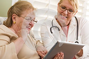 Doctor or Nurse Talking to Senior Woman with Touch Pad