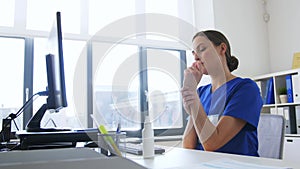 Doctor or nurse using hand sanitizer at hospital