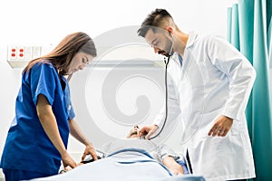 Doctor and nurse working on a patient