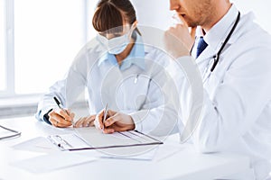 Doctor and nurse writing prescription paper