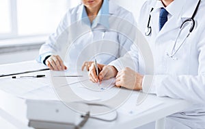 Doctor and nurse writing prescription paper