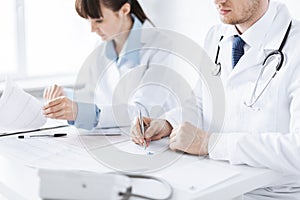 Doctor and nurse writing prescription paper