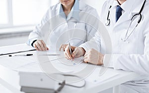 Doctor and nurse writing prescription paper