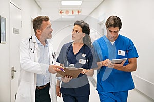 Doctor and nurses discussing patient case at hospital