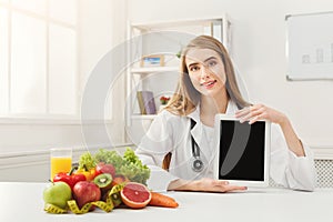 Doctor nutritionist and holding digital tablet