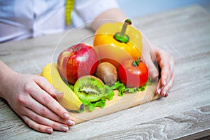 Doctor Nutritionist holding fresh fruits and vegetables for a healthy diet