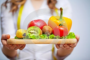 Doctor Nutritionist holding fresh fruits and vegetables for a healthy diet