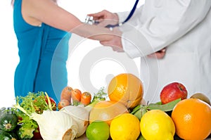 Doctor nutritionist measuring blood pressure of his patient