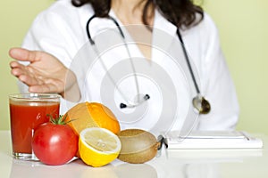 Doctor nutritionist in office with healthy fruits